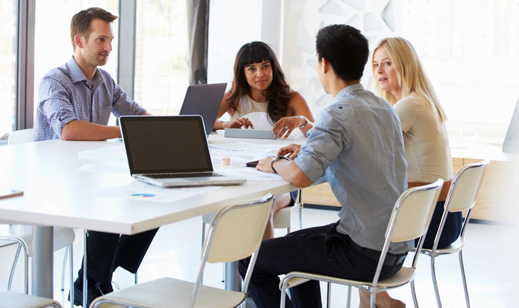 Group of colleagues having a discussion in a modern office