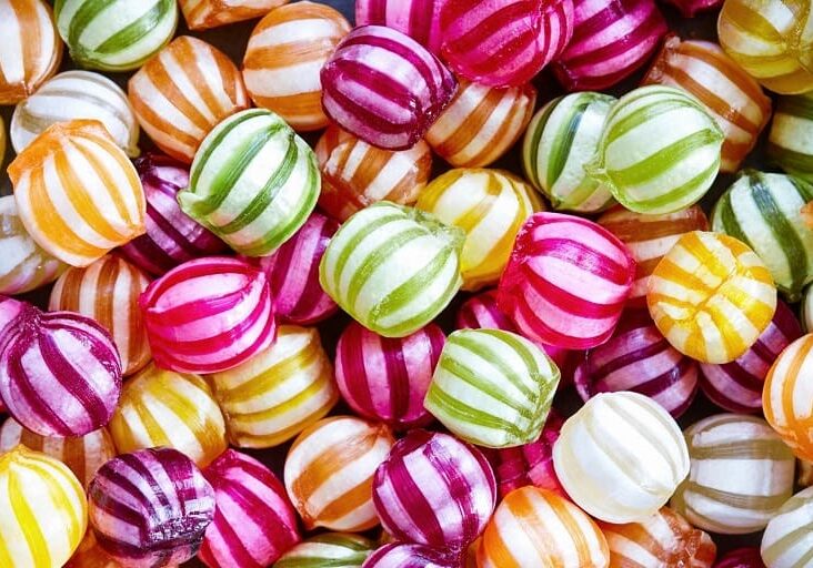 A pile of candy that is colorful and striped.